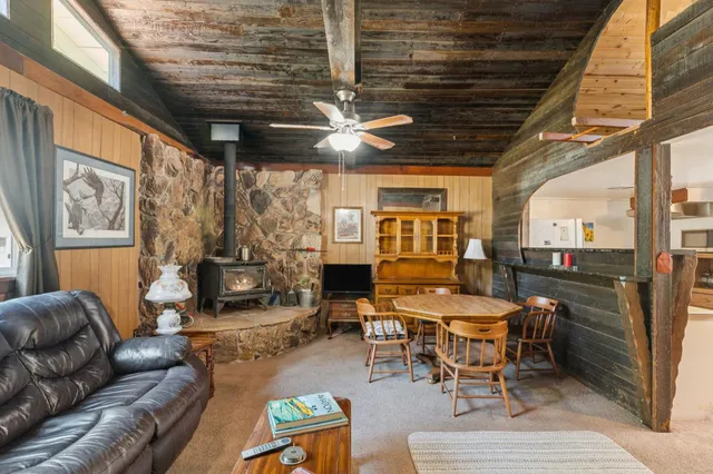 a living room with furniture a fireplace and a table