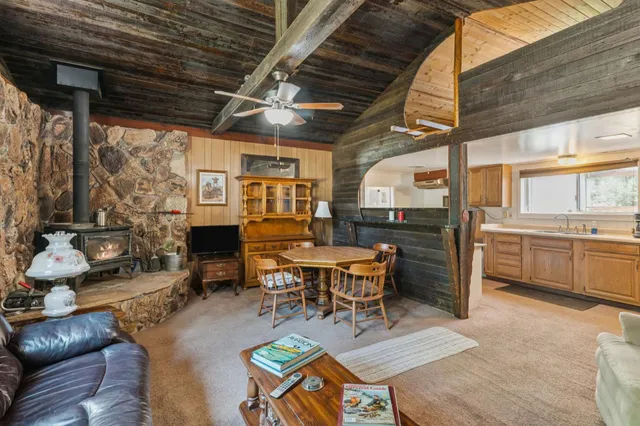 a living room with fireplace furniture and a wooden floor