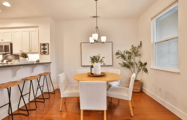 a dining room with furniture and wooden floor