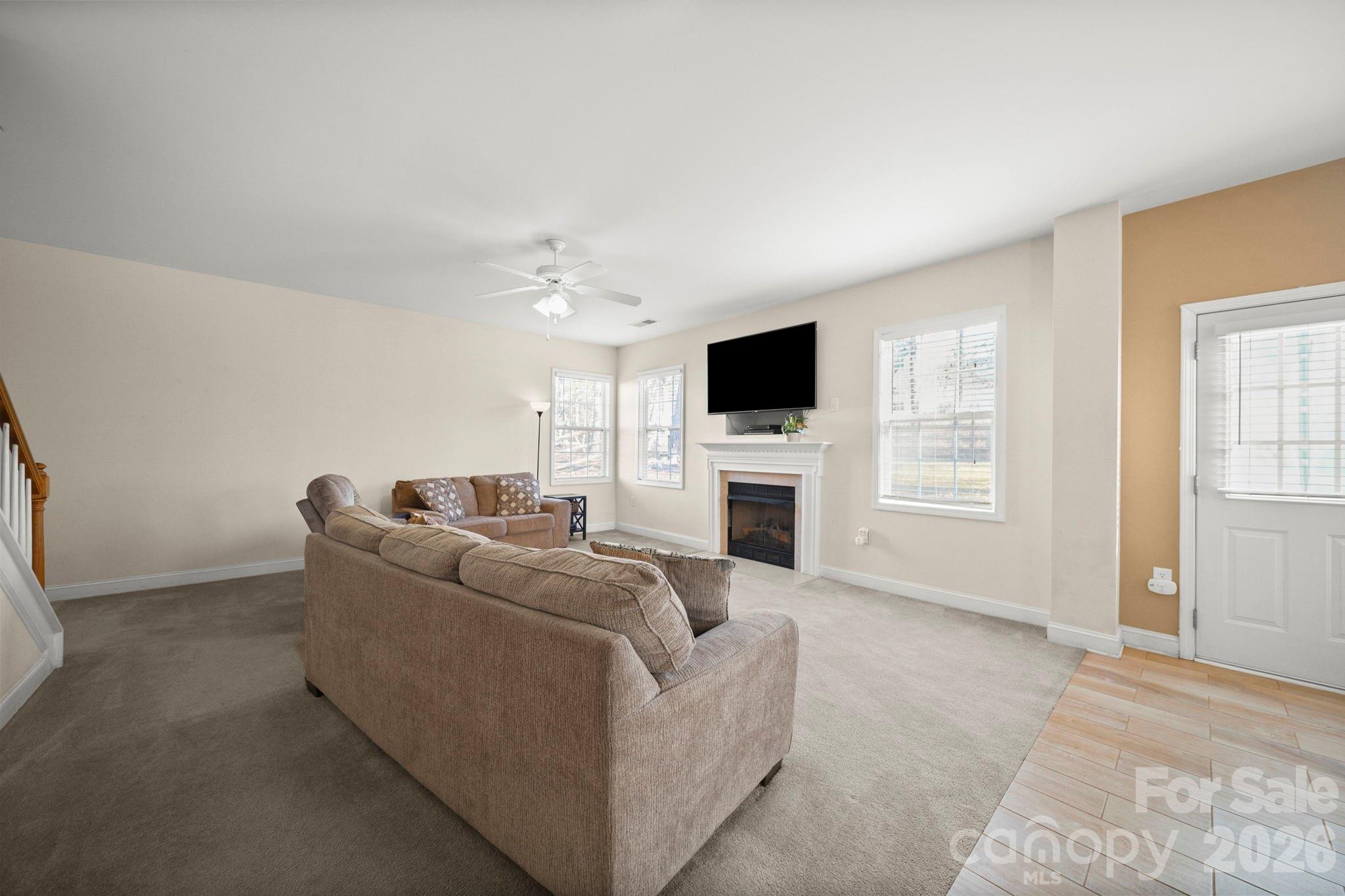 3035 Proverbs Court Monroe, NC 28110 - Photo 17 of 39 a living room with furniture a fireplace and a flat screen tv