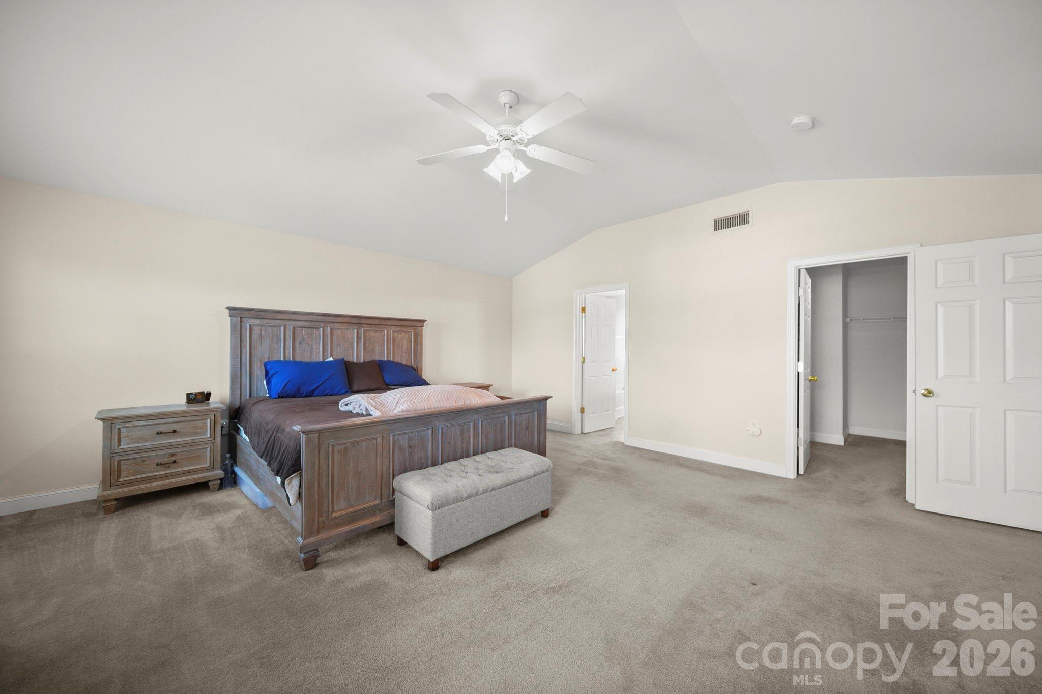 3035 Proverbs Court Monroe, NC 28110 - Photo 20 of 39 a bedroom with a bed and a chandelier