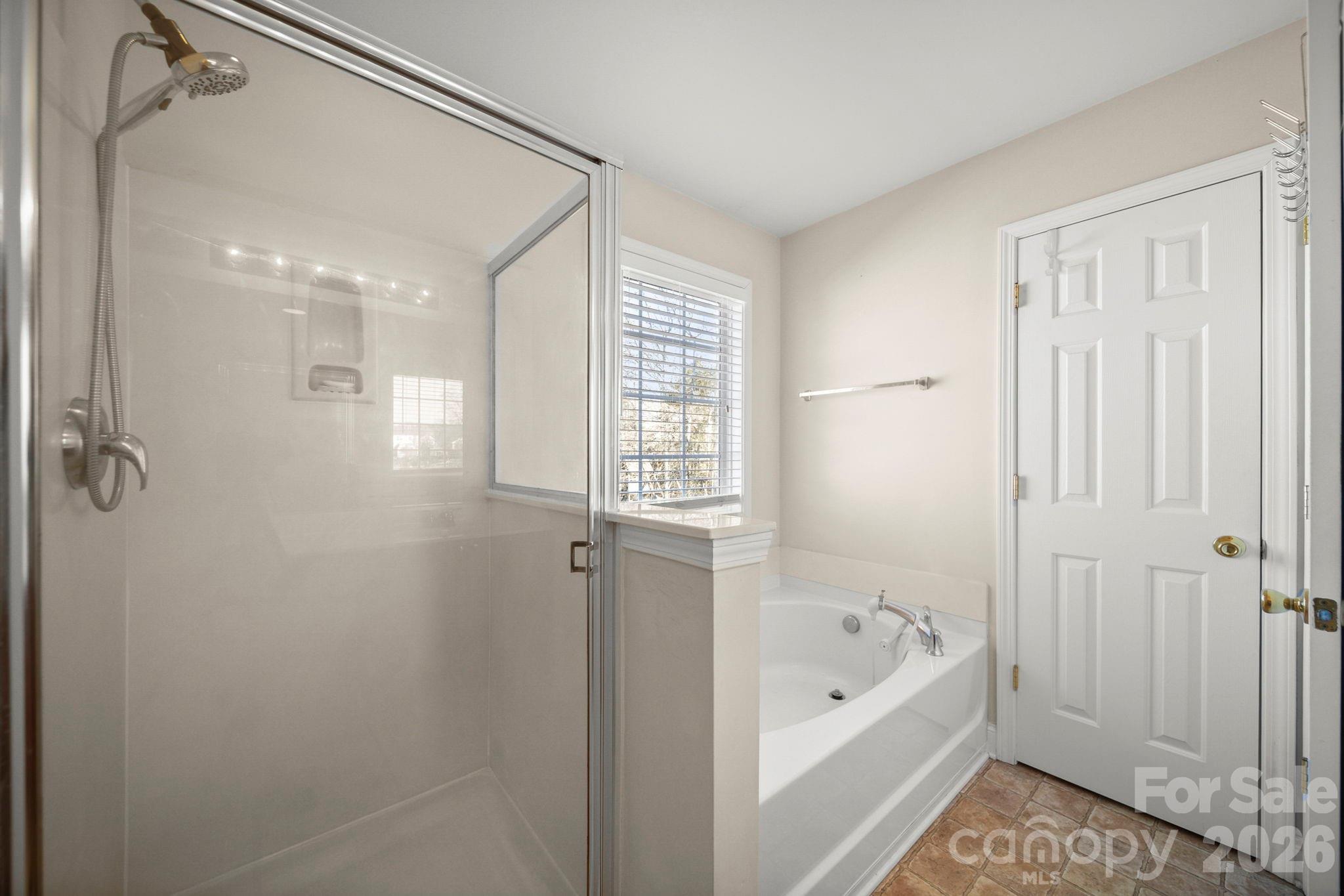 3035 Proverbs Court Monroe, NC 28110 - Photo 21 of 39 a bathroom with a bathtub and a shower