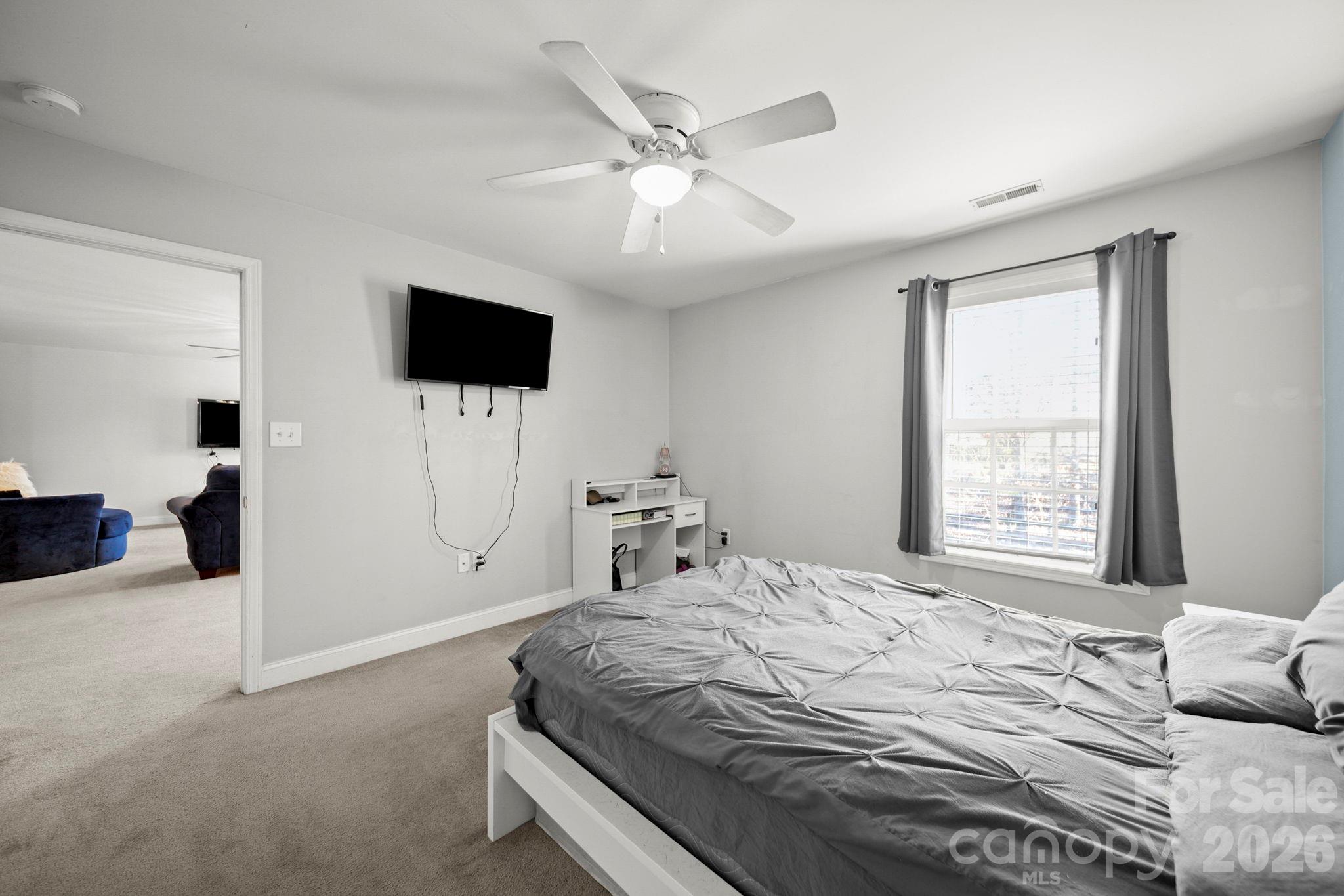 3035 Proverbs Court Monroe, NC 28110 - Photo 26 of 39 a bedroom with a bed and a flat screen tv