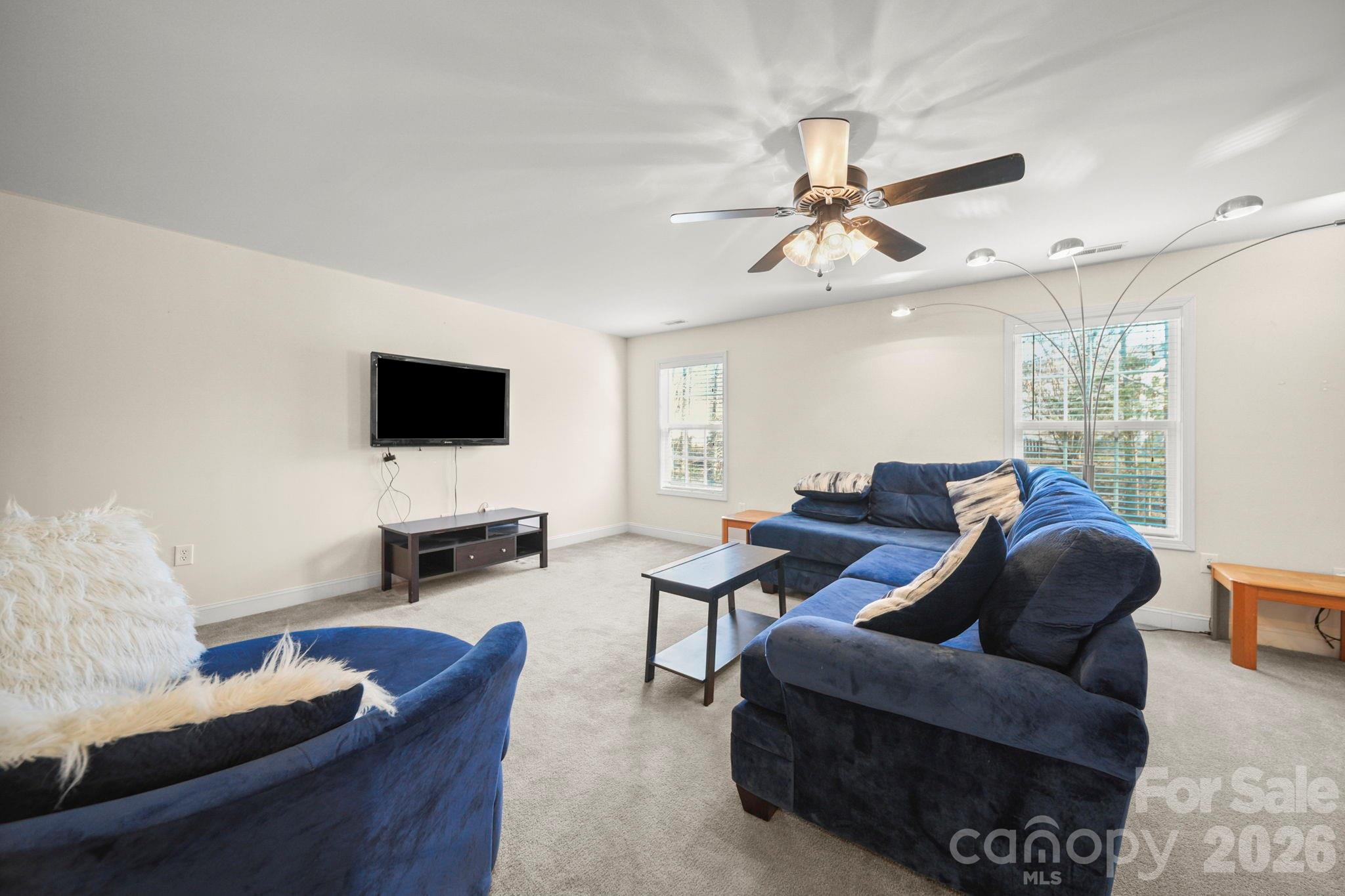 3035 Proverbs Court Monroe, NC 28110 - Photo 29 of 39 a living room with furniture and a flat screen tv