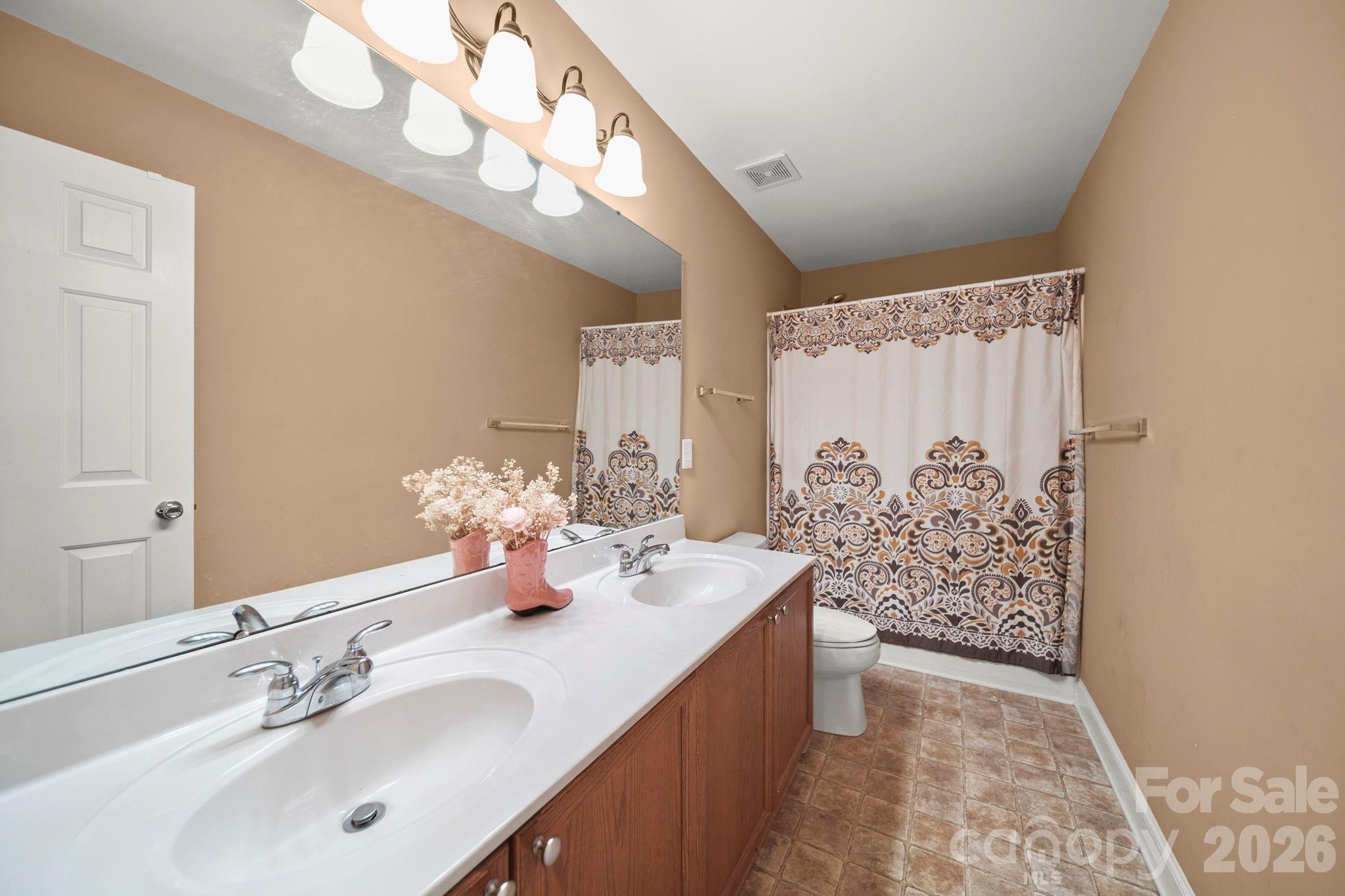 3035 Proverbs Court Monroe, NC 28110 - Photo 30 of 39 a bathroom with a double vanity sink mirror and shower