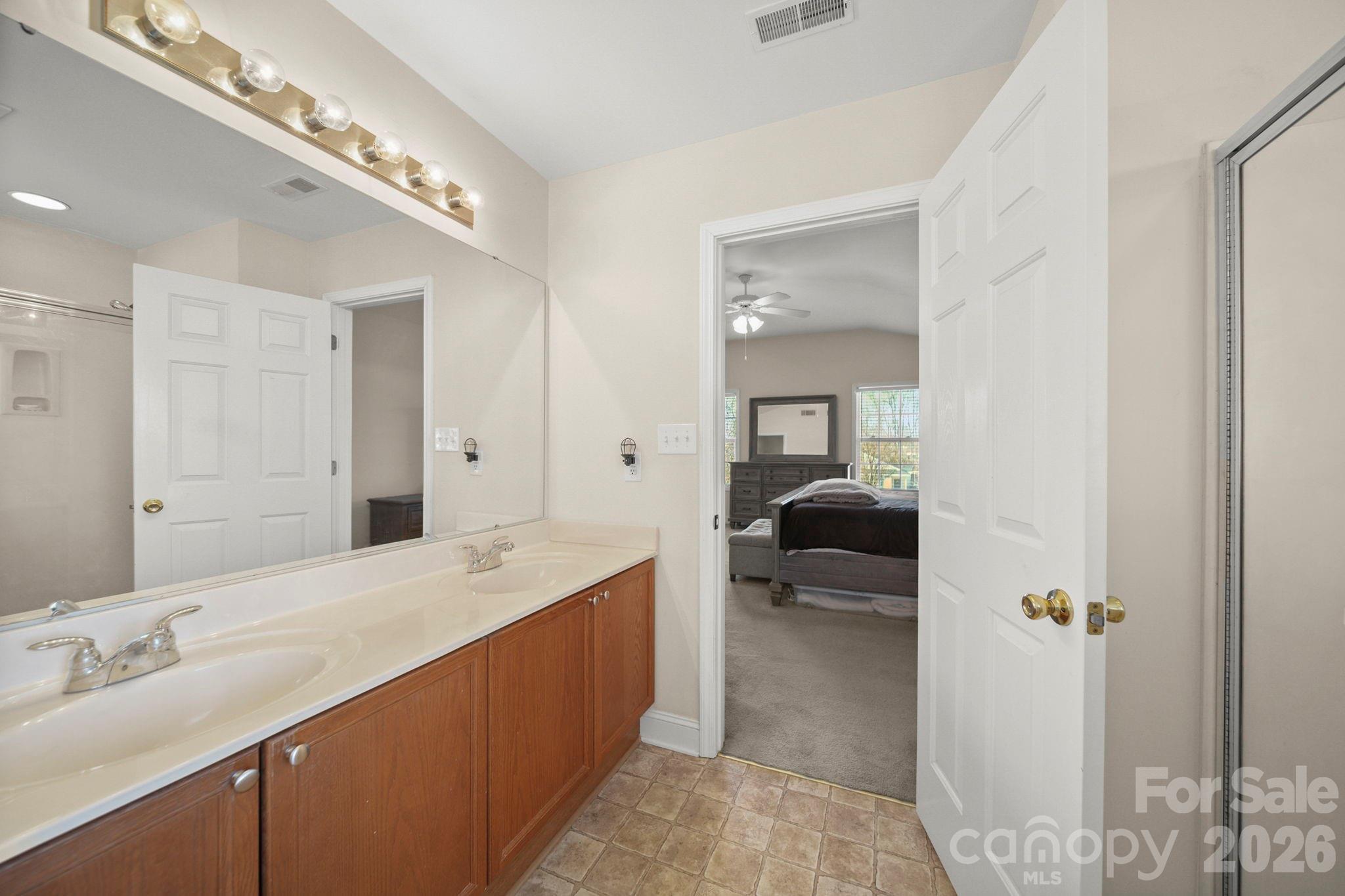 3035 Proverbs Court Monroe, NC 28110 - Photo 32 of 39 a en suite bathroom with a sink and mirror