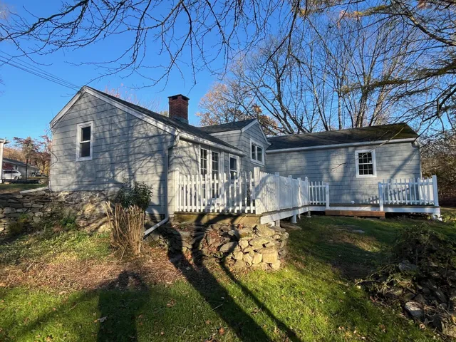 a view of a house with backyard and sitting area