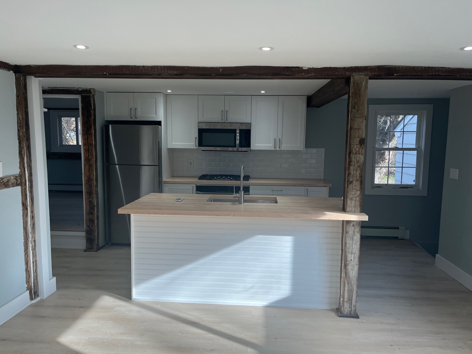 434 Hurlbutt Street Wilton, CT 06897 - Photo 3 of 14 a kitchen with kitchen island a sink stainless steel appliances and cabinets
