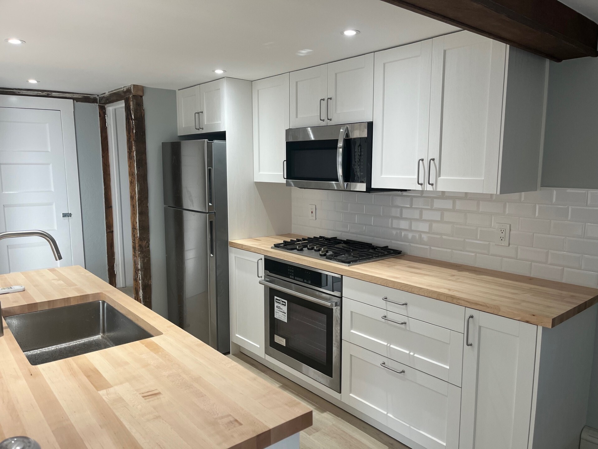 434 Hurlbutt Street Wilton, CT 06897 - Photo 4 of 14 a kitchen with stainless steel appliances kitchen island granite countertop a refrigerator sink and white cabinets