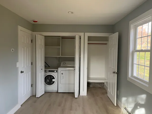 a view of a storage & utility room with a washer dryer