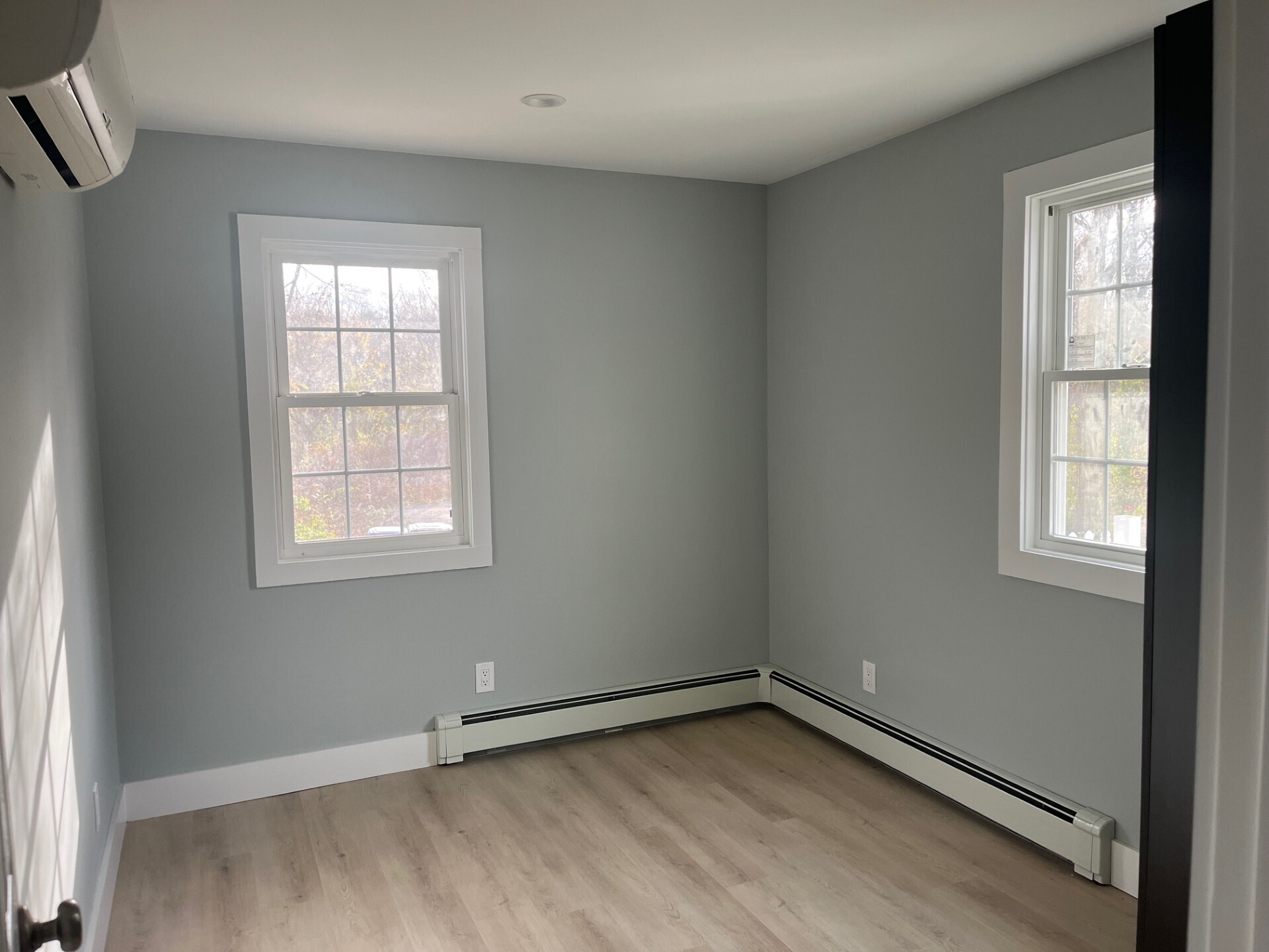434 Hurlbutt Street Wilton, CT 06897 - Photo 10 of 14 an empty room with wooden floor and windows