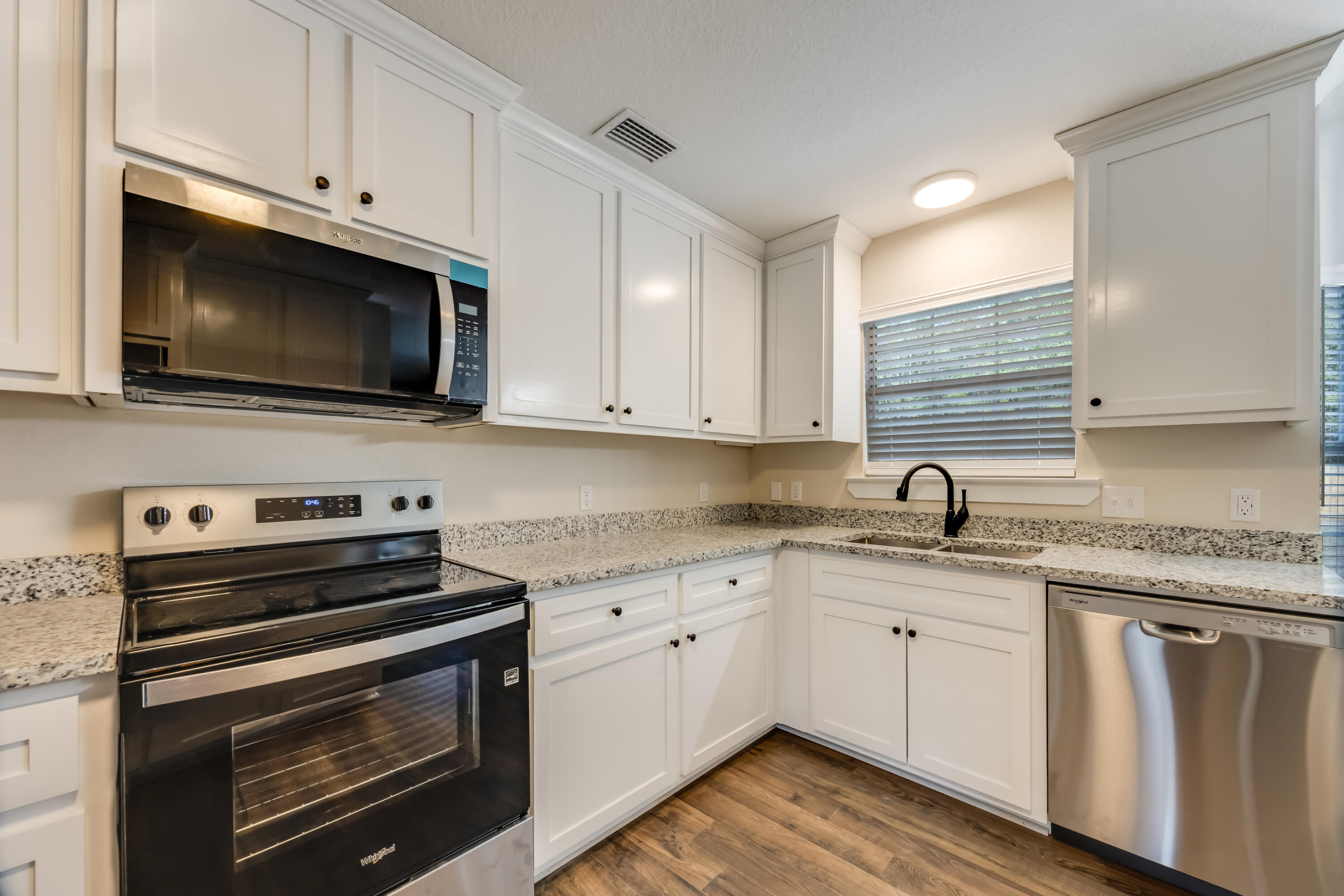 3005 Lillie Street Crestview, FL 32539 - Photo 12 of 46 a kitchen with cabinets stainless steel appliances a sink and a stove
