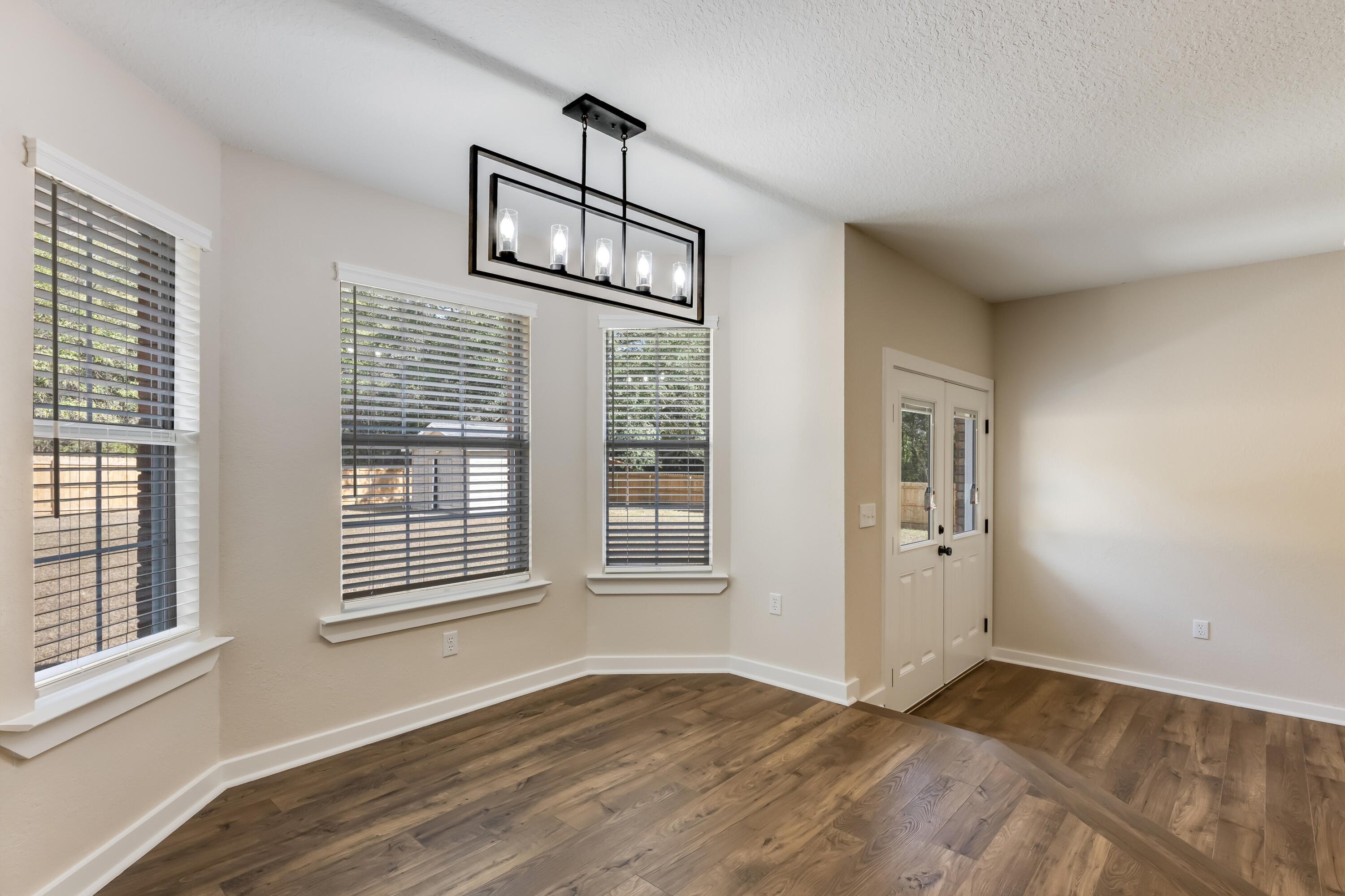 3005 Lillie Street Crestview, FL 32539 - Photo 14 of 46 a view of an empty room with wooden floor and fan