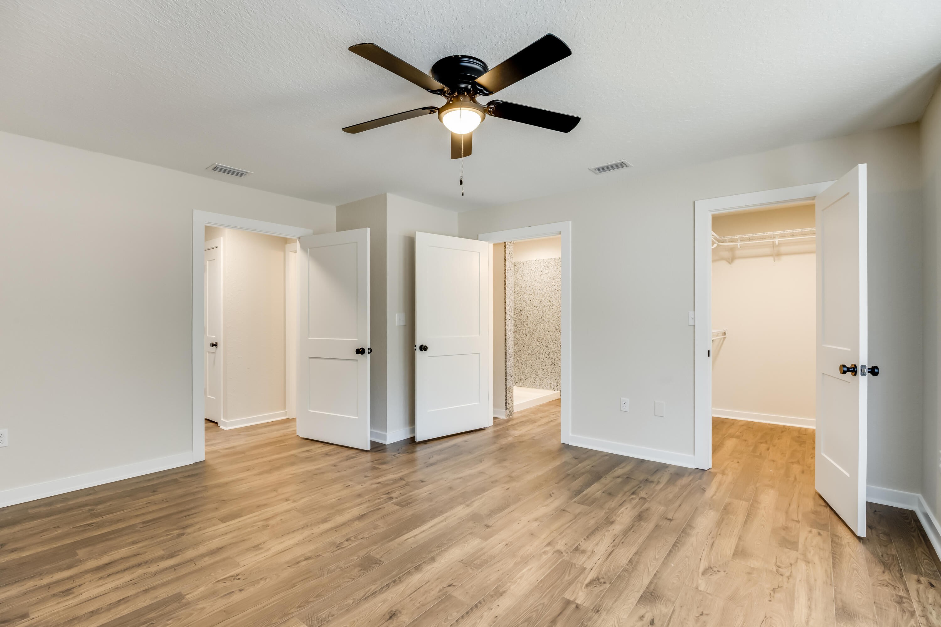 3005 Lillie Street Crestview, FL 32539 - Photo 20 of 46 a view of an empty room with wooden floor