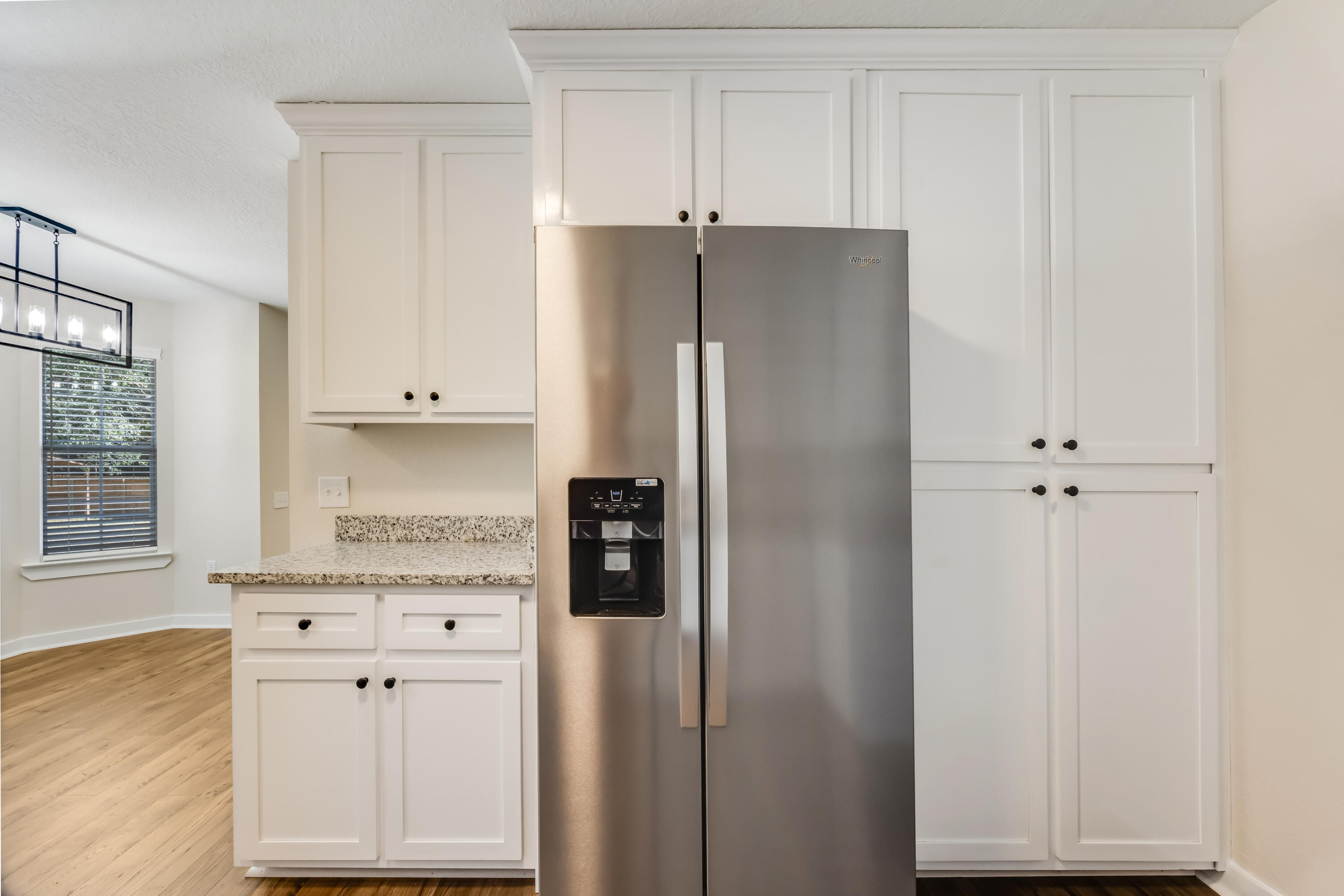 3005 Lillie Street Crestview, FL 32539 - Photo 9 of 46 a kitchen with stainless steel appliances white cabinets and a refrigerator