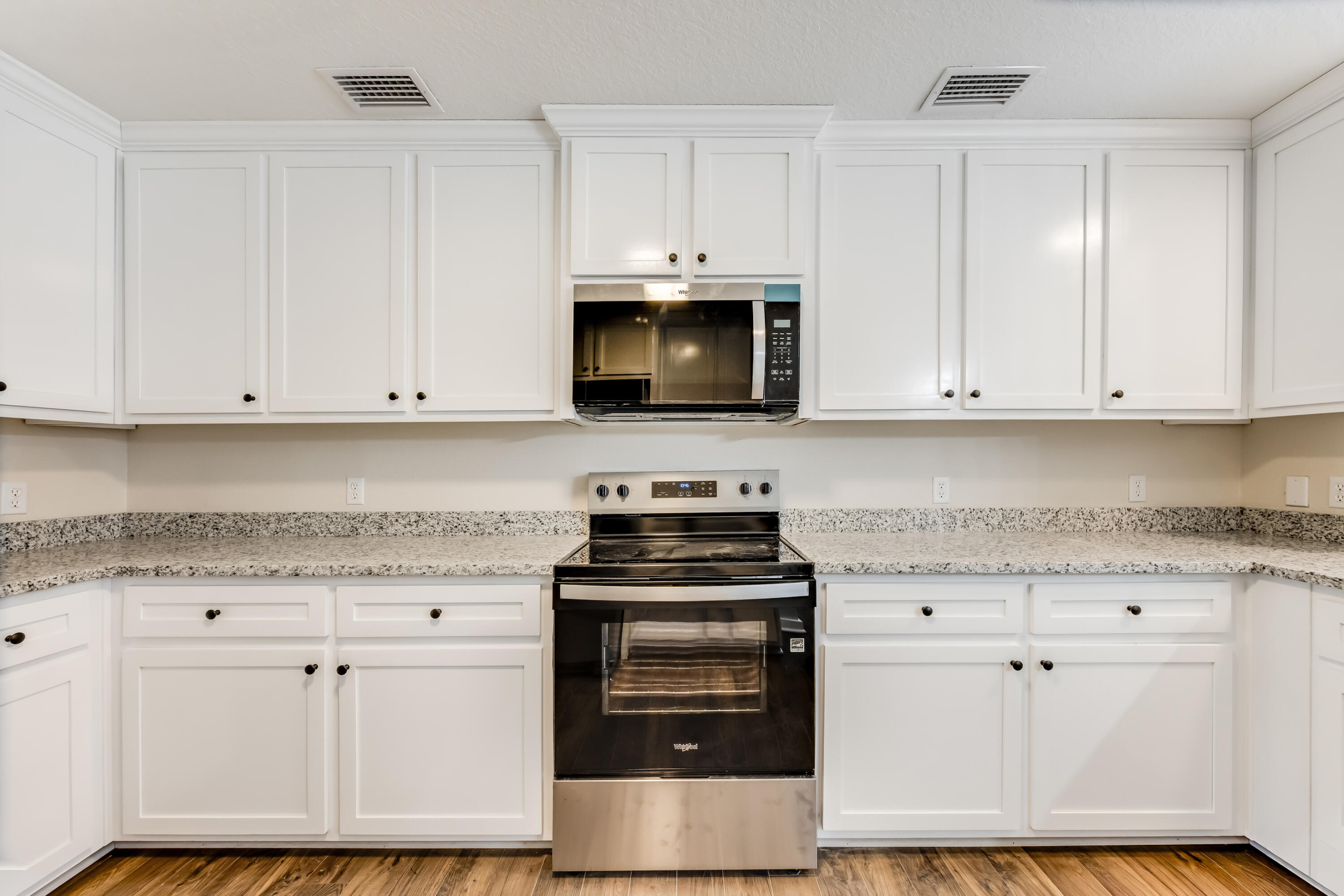 3005 Lillie Street Crestview, FL 32539 - Photo 10 of 46 a kitchen with granite countertop white cabinets and stainless steel appliances