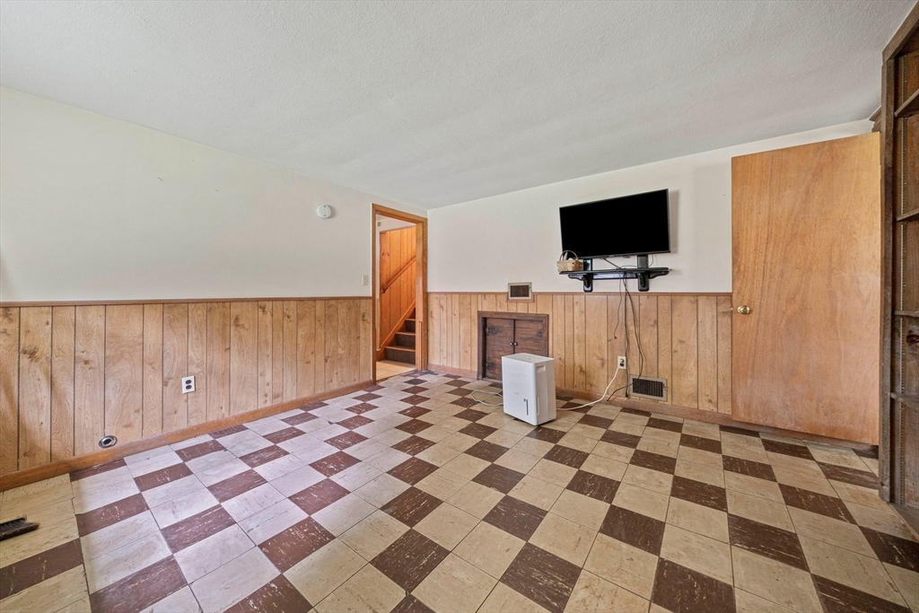 4 Lakeview Road Foxboro, MA 02035 - Photo 20 of 32 a living room with a black white checkered floor