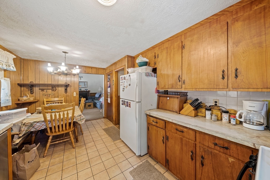4 Lakeview Road Foxboro, MA 02035 - Photo 9 of 32 a kitchen with refrigerator cabinets dining table and chairs