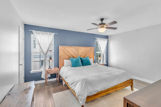 a bedroom with a bed and a chandelier