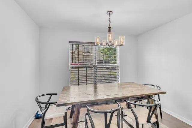 a view of a dining room with furniture and chandelier