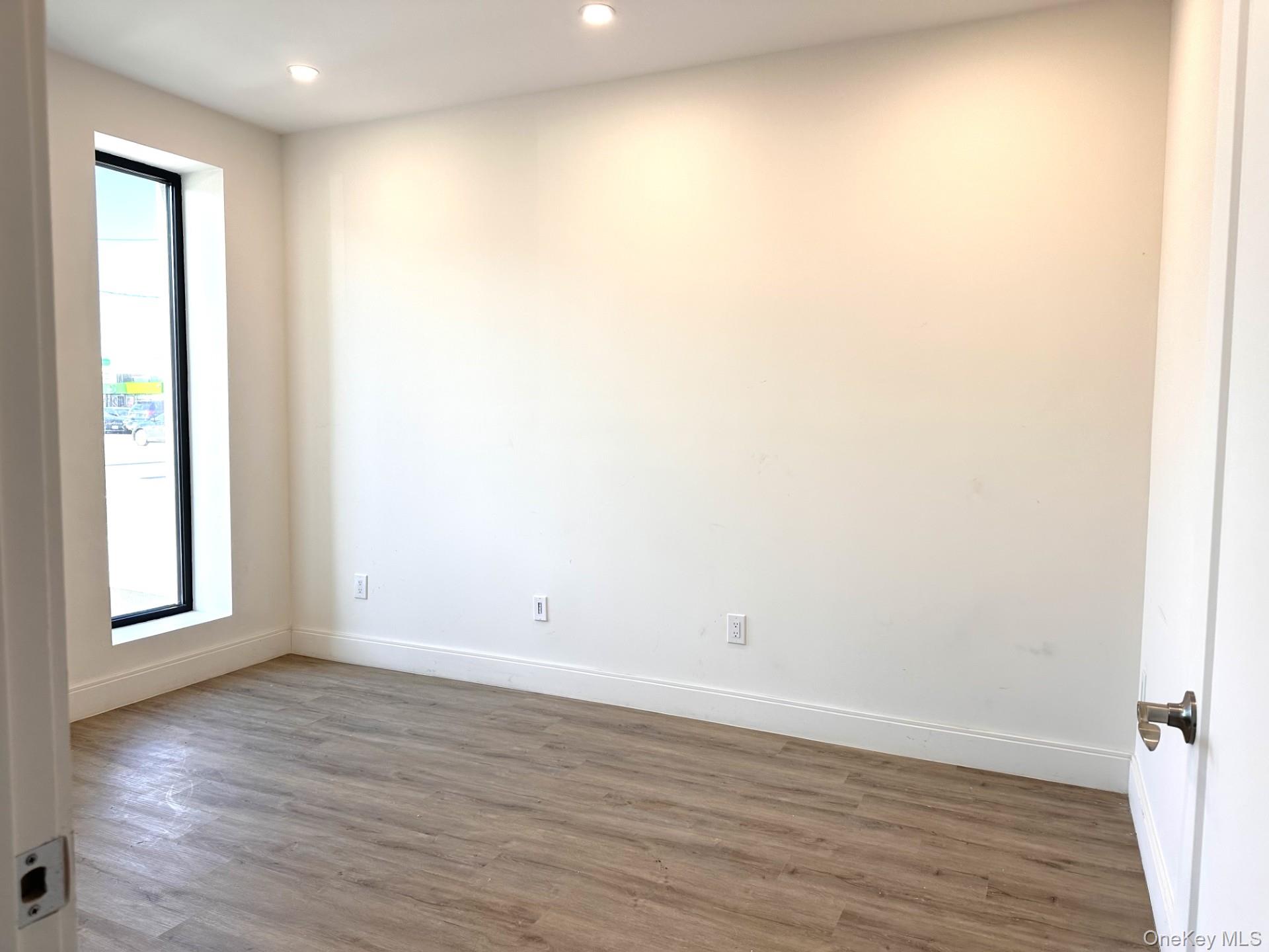 362 West Merrick Road, Unit 101 Valley Stream, NY 11580 - Photo 5 of 9 Spare room featuring wood finished floors and recessed lighting