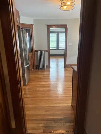 a view of hallway with stairs and a window