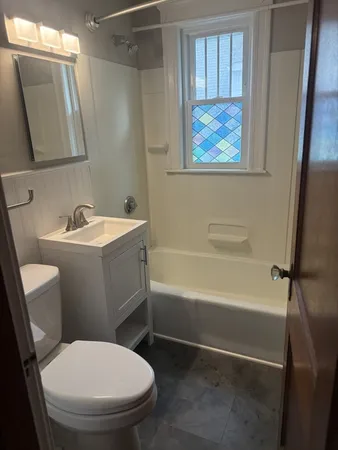 a bathroom with a toilet a sink and bathtub