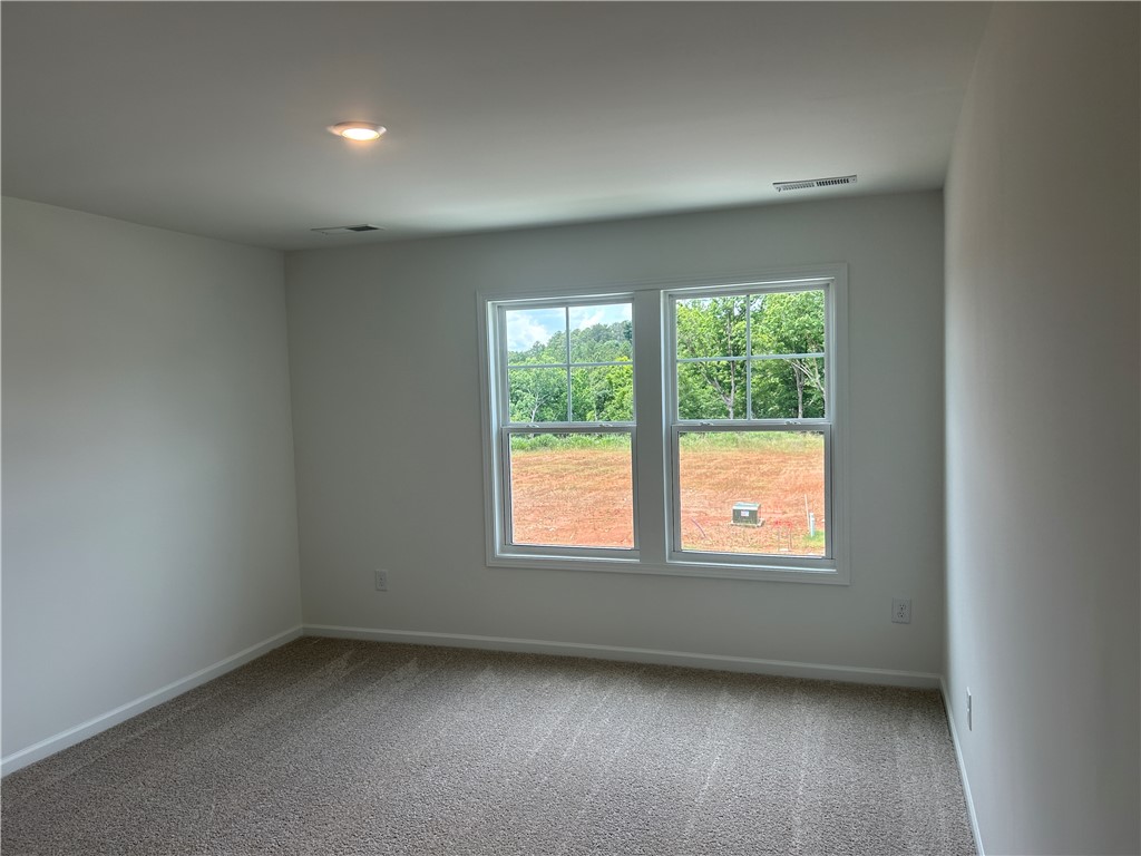 217 Bellflower Lane Anderson, SC 29625 - Photo 22 of 27 Naturally illuminated interiors and soft carpeting welcome you into this cozy room.