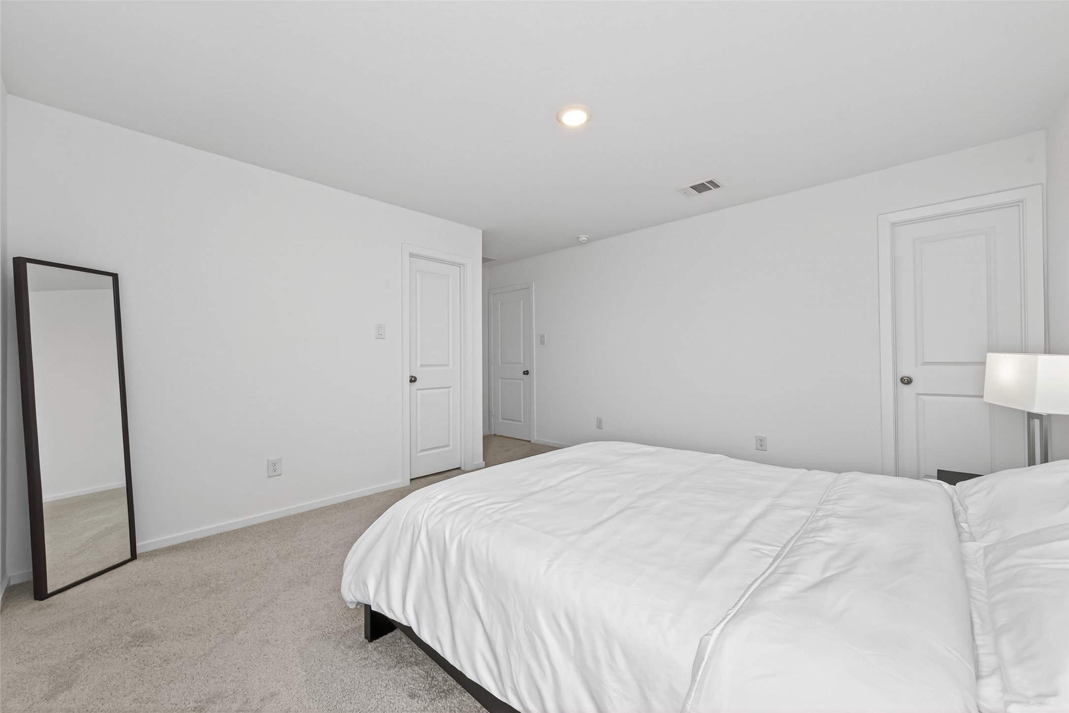 10720 Ellerston Road Cleveland, TX 77327 - Photo 24 of 32 This spacious living room features light wood flooring, a cozy sectional sofa, modern decor, and ample natural light from large windows. It's a perfect space for relaxation and entertainment.