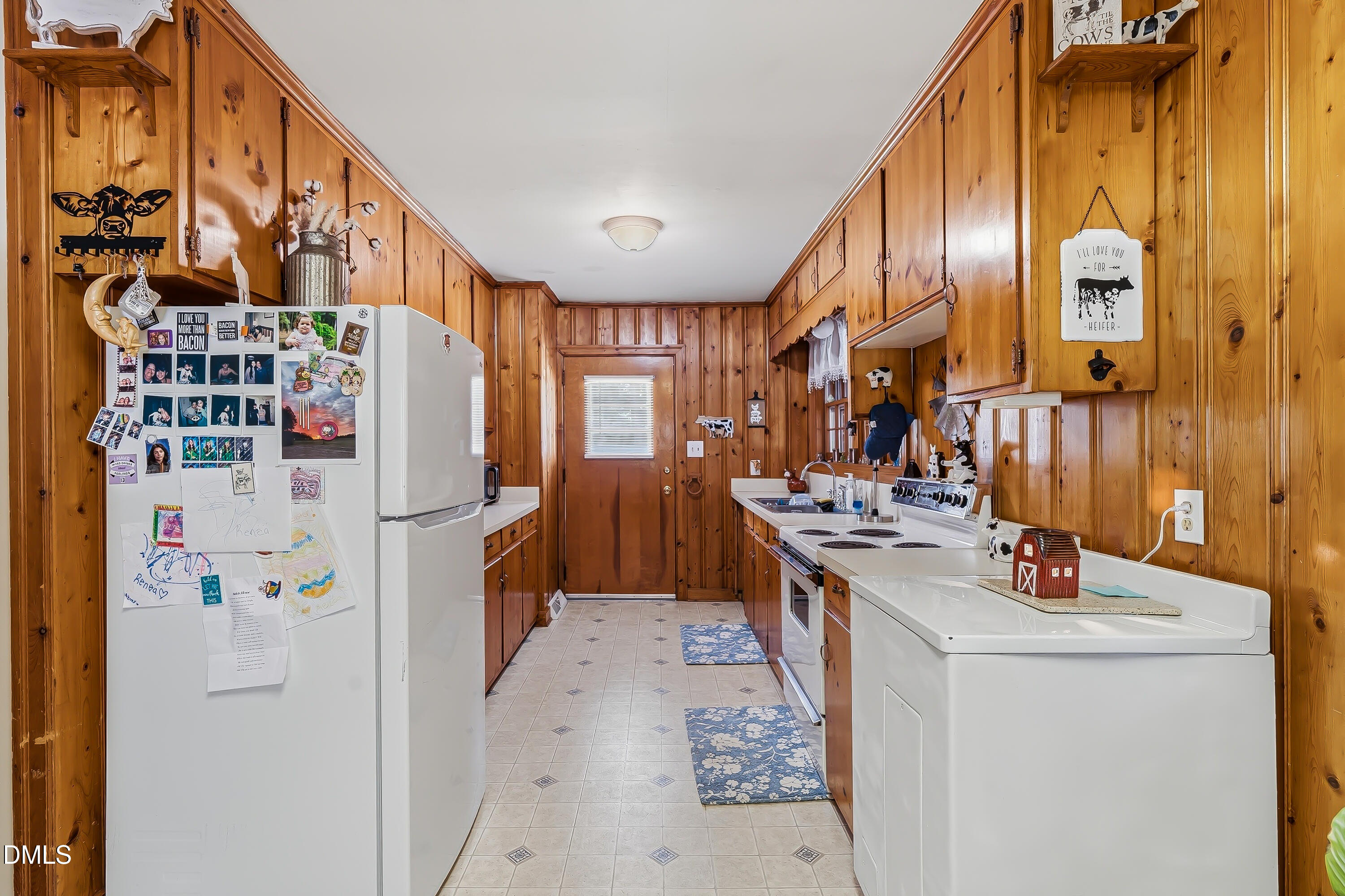 4967 Highway 581 Spring Hope, NC 27882 - Photo 23 of 44 a kitchen with stainless steel appliances a sink a stove a refrigerator and cabinets