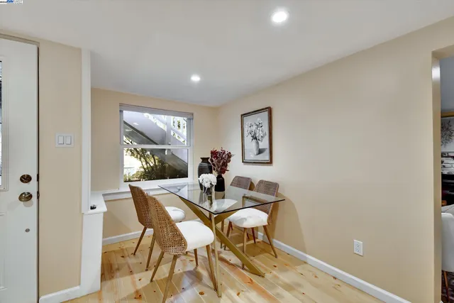 a dining room with furniture and a window