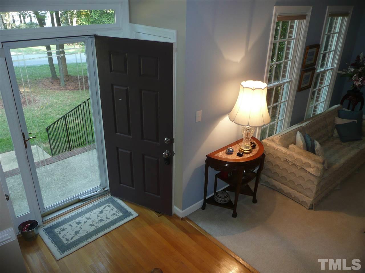 2604 Sunnystone Way Raleigh, NC 27613 - Photo 2 of 25 a living room with furniture and a lamp