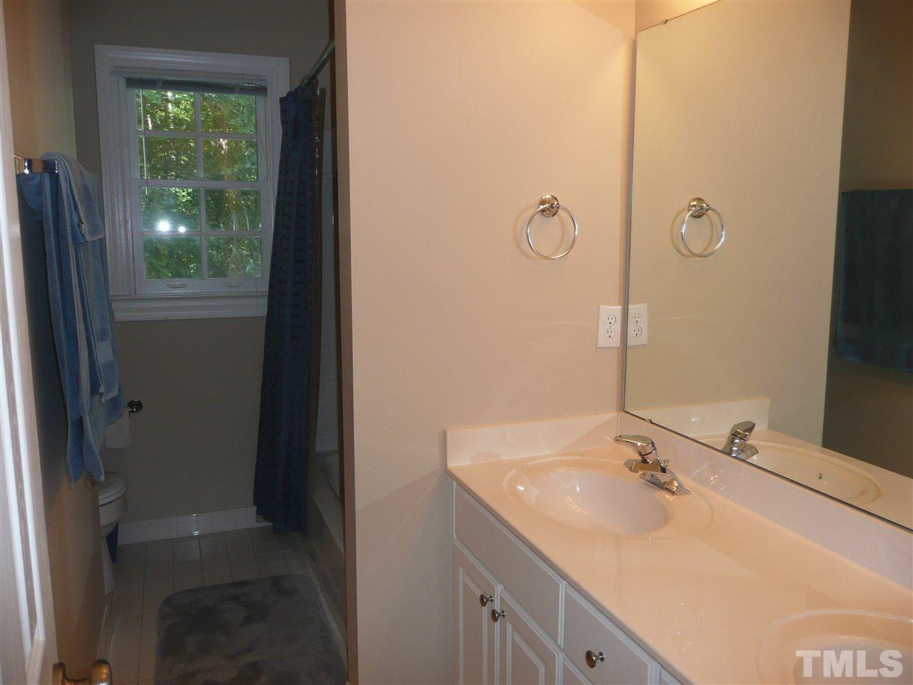 2604 Sunnystone Way Raleigh, NC 27613 - Photo 16 of 25 a bathroom with a sink and a mirror