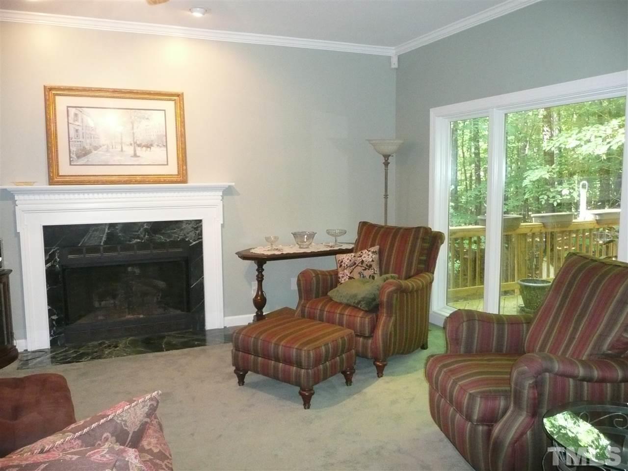2604 Sunnystone Way Raleigh, NC 27613 - Photo 6 of 25 a living room with furniture and a fireplace