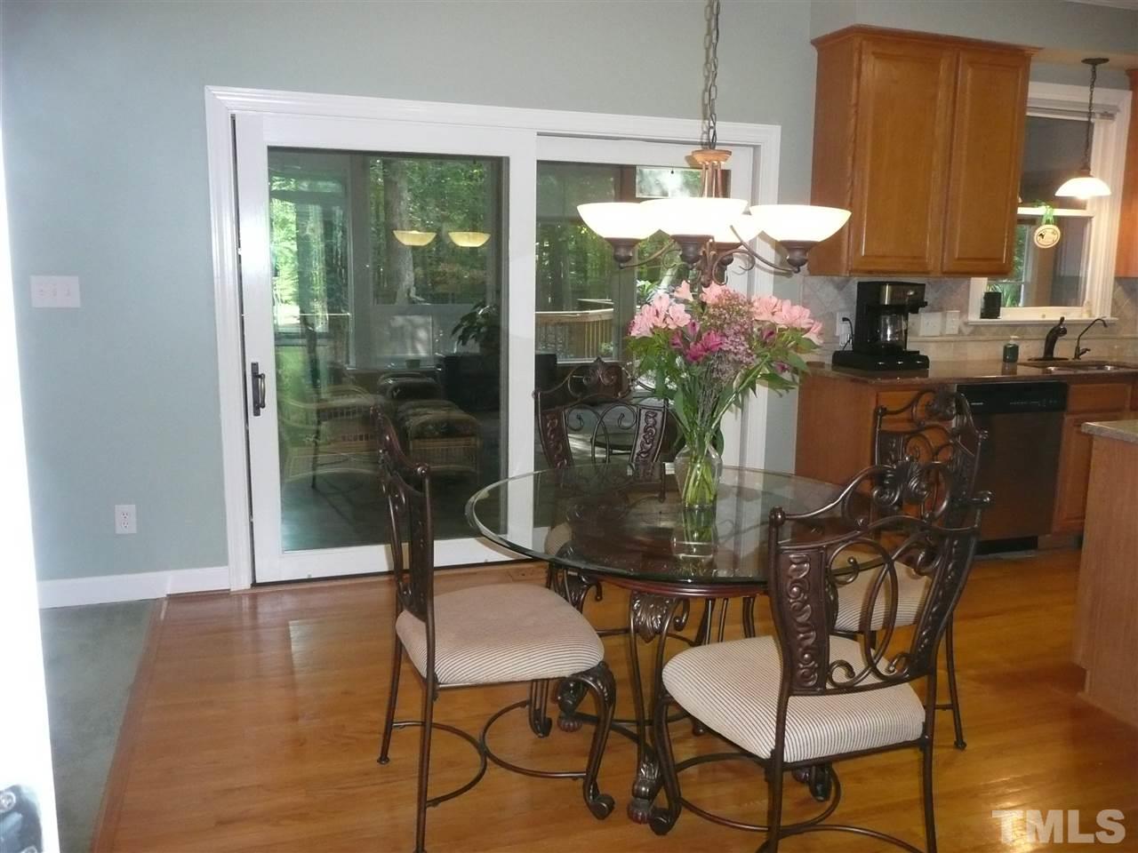 2604 Sunnystone Way Raleigh, NC 27613 - Photo 8 of 25 a dining room with furniture and wooden floor