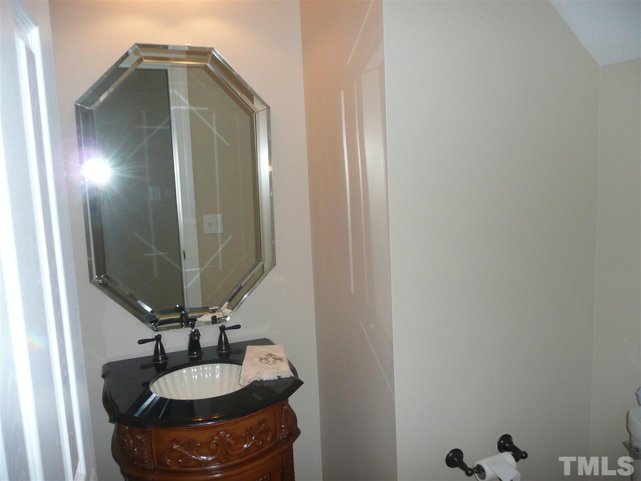 2604 Sunnystone Way Raleigh, NC 27613 - Photo 10 of 25 a bathroom with a sink and a mirror