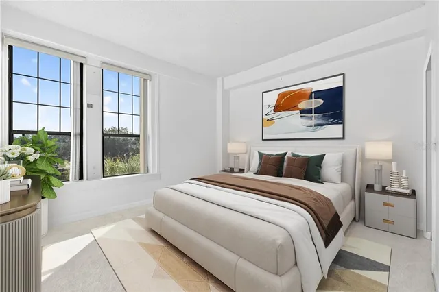 a spacious bedroom with a bed and a window