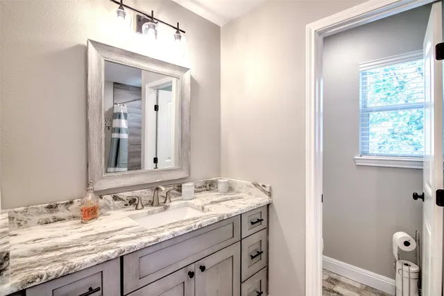a bathroom with a glass shower door