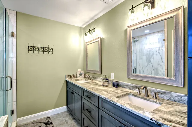 a bathroom with a glass shower door