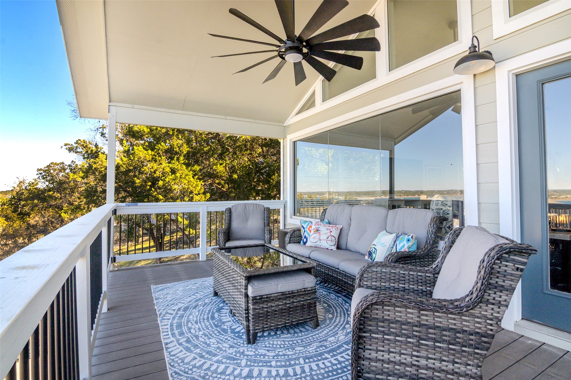 1526 Lakeside Drive West Canyon Lake, TX 78133 - Photo 22 of 35 The balcony sitting area is perfect for happy hour with sofa, oversized cushioned chairs, 2 ottomans plus tables . A 12 blade Minka Aire fan insures a comfortable afternoon regardless of the season.