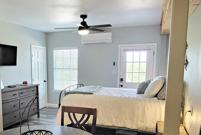 a bedroom with a bed with wooden floor