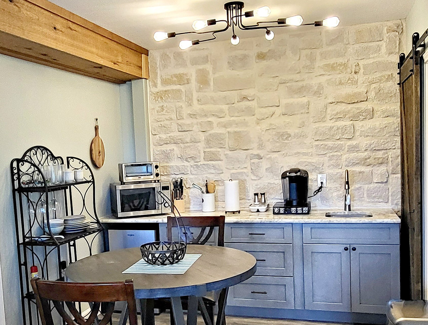 1526 Lakeside Drive West Canyon Lake, TX 78133 - Photo 27 of 35 Kitchenette w/ Granite counters, Keurig, fridge, toaster oven. A hill country flair has been added with the limestone faced back facing.