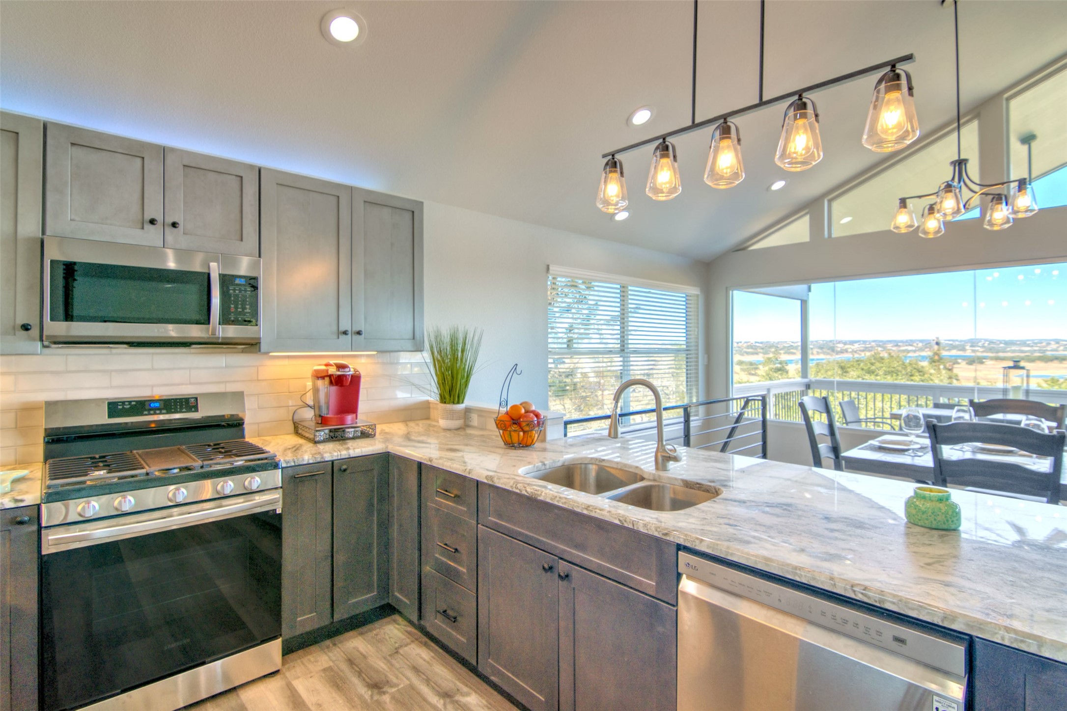 1526 Lakeside Drive West Canyon Lake, TX 78133 - Photo 10 of 35 If you’ve got to wash dishes, this is the view you want while doing it! Dishwasher, gas stove, walk in pantry, everything you need.