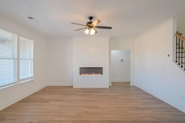 wooden floor in an empty room with a window