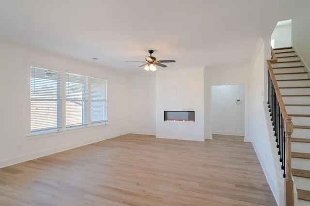 a kitchen with granite countertop a sink a counter space appliances and cabinets