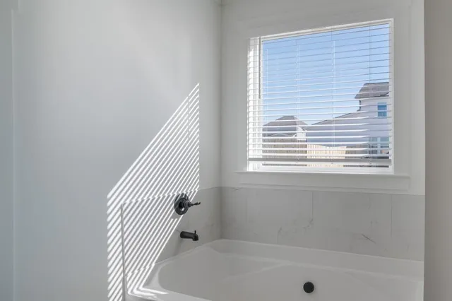 a bath tub sitting next to a window