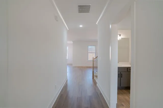 a view of hallway with wooden floor