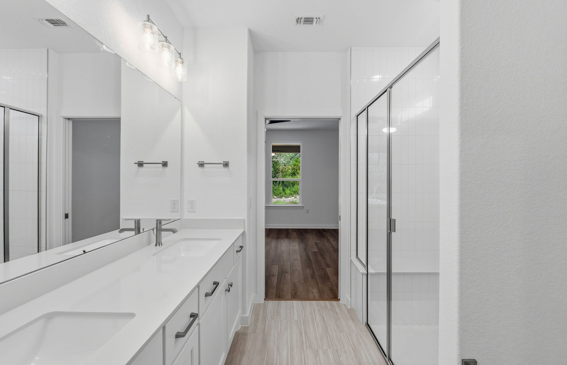 1010 Martingale Street Georgetown, TX 78633 - Photo 10 of 23 a bathroom with a sink a mirror and a shower
