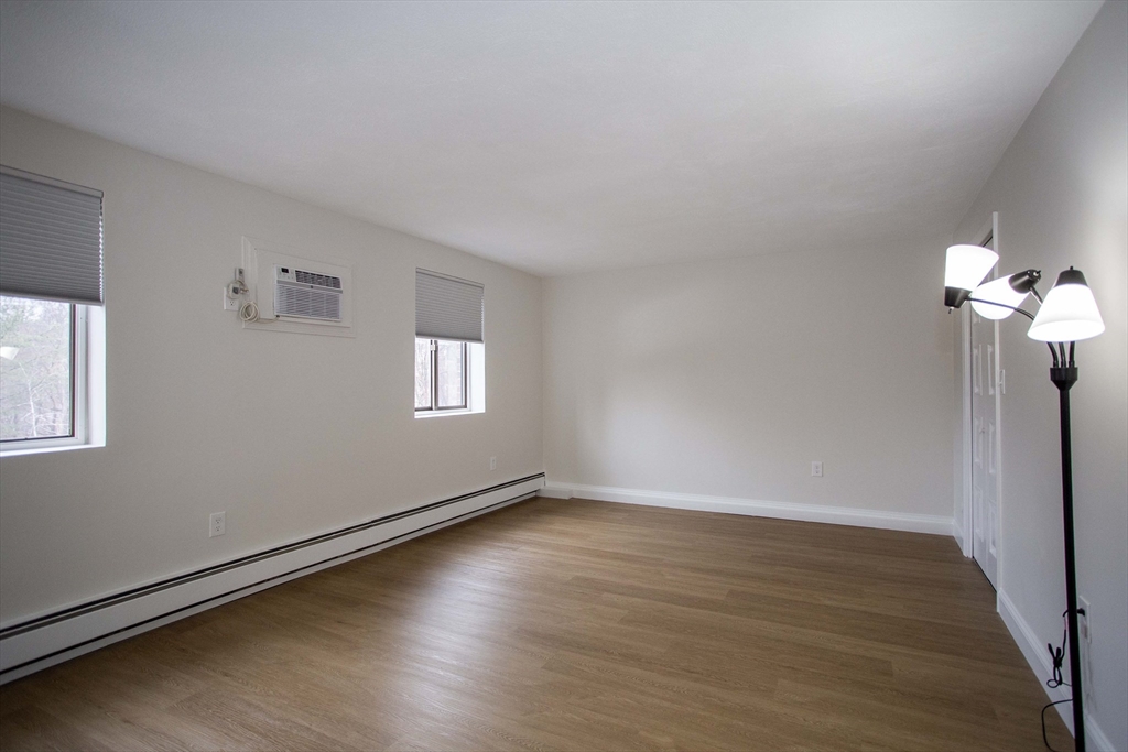 5 Washington Street, Unit C9 Reading, MA 01867 - Photo 14 of 21 a view of an empty room with wooden floor and a window