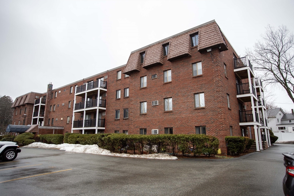 5 Washington Street, Unit C9 Reading, MA 01867 - Photo 20 of 21 a front view of a building with parking space